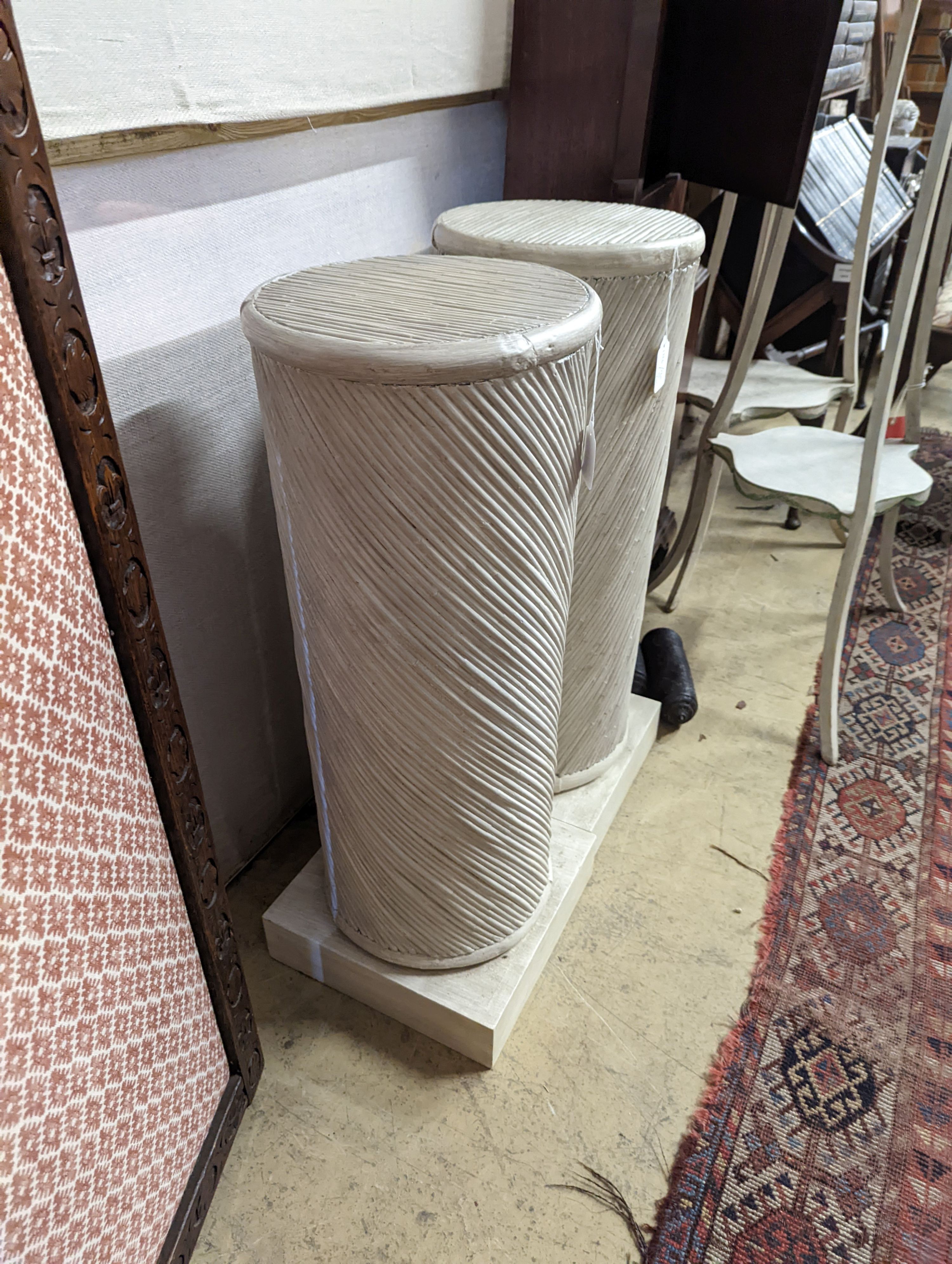 A pair of painted spiral moulded columns, Colefax & Fowler, diameter 30cm, height 79cm